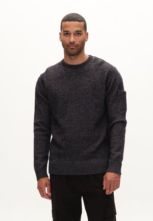 Dark grey knitted sweater with a crew neckline, textured fabric, ribbed cuffs, and hem, featuring a patch pocket on the left sleeve.