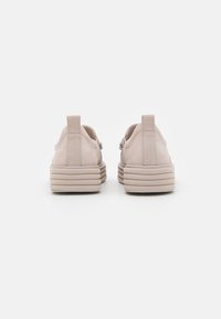 Hellebeige Sneakers mit einer runden Form, einem strukturierten Wildleder-Obermaterial, einem gepolsterten Schaft und übereinanderliegenden Gummisohlen für zusätzlichen Halt.
