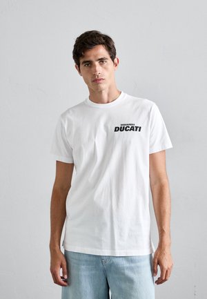 White cotton t-shirt featuring a crew neck and short sleeves, with a black graphic print that includes "DSQUARED2" and "DUCATI" on the front.