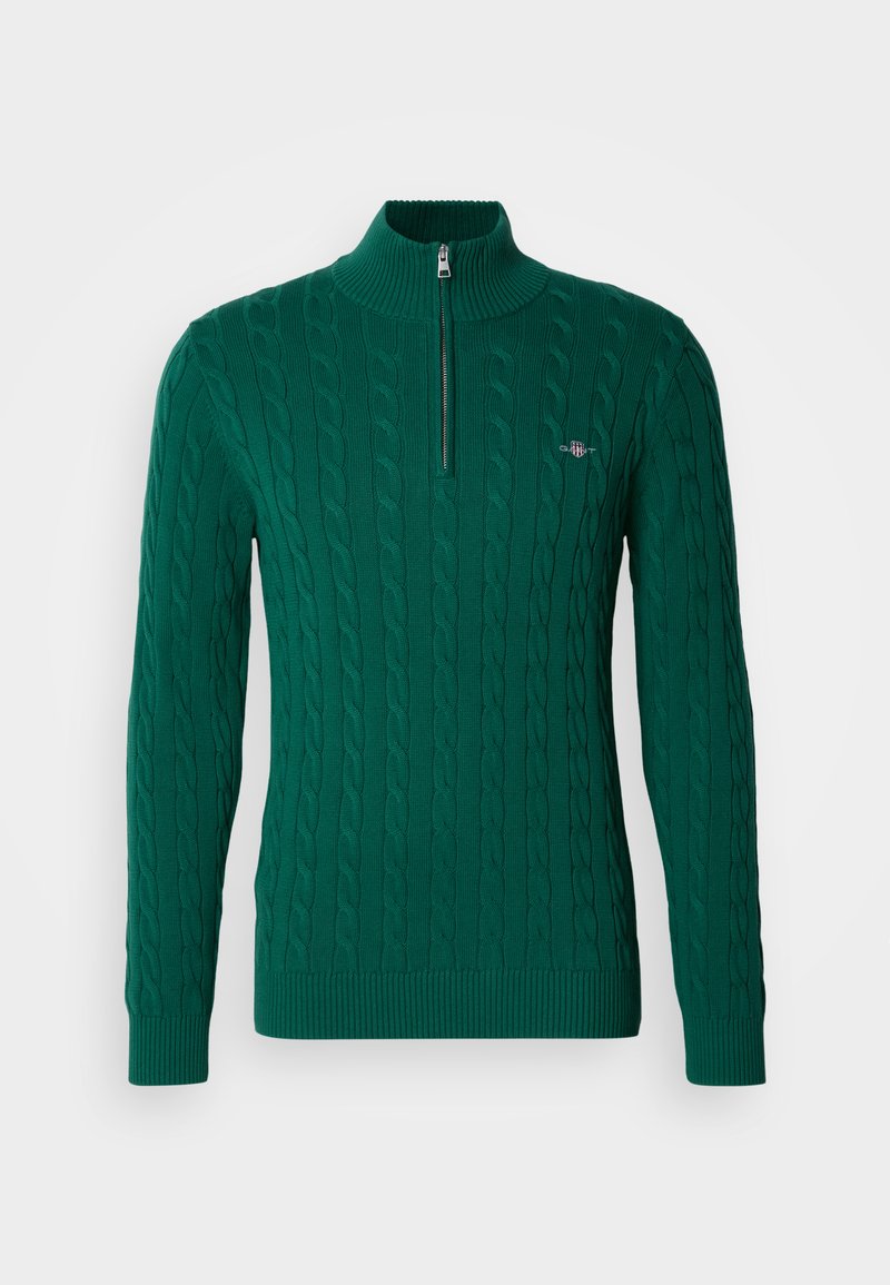 Green knit pullover with a high collar and half-zipper. Features a cable pattern and ribbed cuffs and hem.