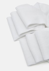 White fabric, softly textured, arranged in folds. The material is lightweight with a smooth finish, showing subtle variations in thickness.