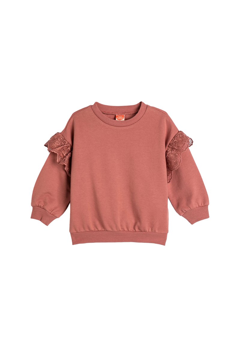 Różowy sweatshirt z długimi rękawami, prążkowanymi mankietami i dołem oraz koronkowymi falbankami na ramionach. Wykonany z miękkiego materiału.