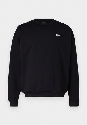 Black sweatshirt with a crew neckline, ribbed cuffs, and hem. Features a small white logo on the chest. Made of cotton fabric.