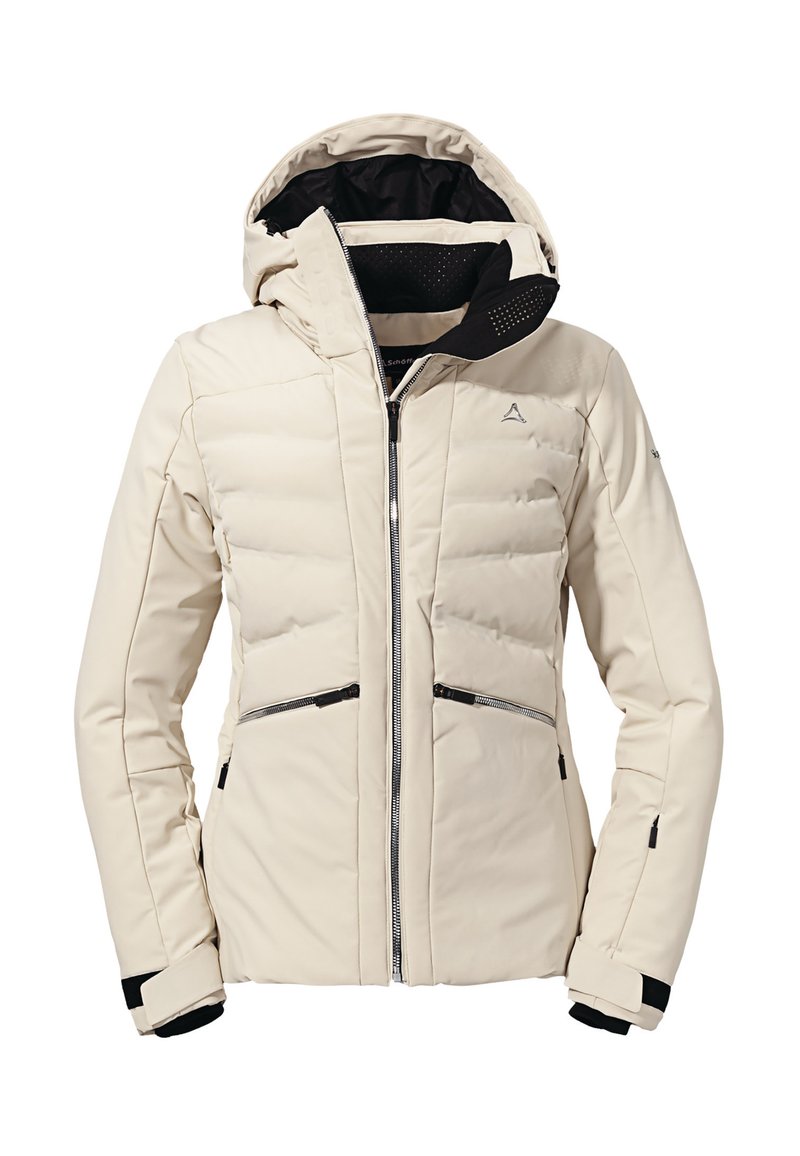 Giubbotto imbottito di un beige chiaro, con chiusura a zip sul davanti, cappuccio regolabile, dettagli neri e tasche con zip; texture liscia con motivo trapuntato.