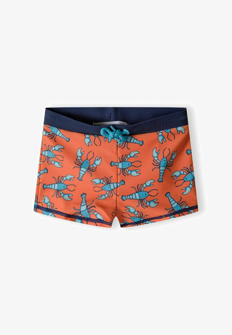 Shorts de bain orange vif avec un motif de pêches bleues. Dotés d'une taille contrastante marine et d'un cordon de serrage teal. Texture de tissu lisse.