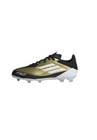Botas de fútbol negras y doradas con un diseño elegante, que cuentan con tres rayas blancas, un upper texturizado y pequeños tacos blancos para el agarre.