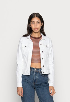 White denim jacket with two chest pockets, silver metal buttons, and a structured fit, worn over a striped crop top and high-waisted jeans.