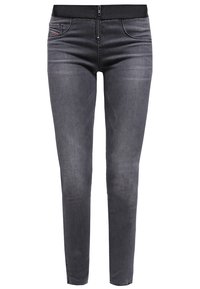 Smal passform svarta denimbyxor med en slät textur, dragkedja och en flexibel midja. Har framfickor och diskreta sömdetaljer.