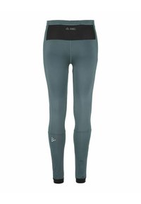 Volledige sportleggings in teal, met een zwarte tailleband, een gladde textuur en reflecterende logo-accenten bij de enkel.