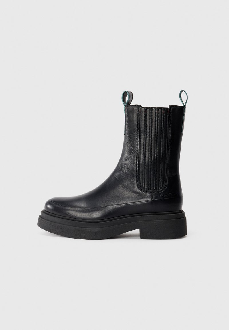 Black leather ankle boot with ribbed elastic side panels, pull tabs, a thick platform sole, and smooth finish.