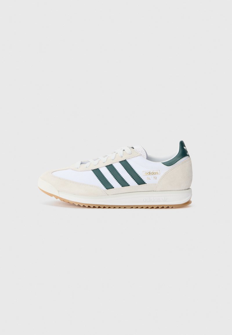 White athletic shoe with green stripes, suede accents, and a textured rubber sole. Features a classic design and lace-up closure.