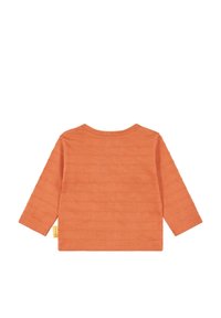 Koszula z długim rękawem w kolorze pomarańczowym, wykonana z textured cotonu. Posiada okrągły dekolt oraz małą metkę z logo z boku.
