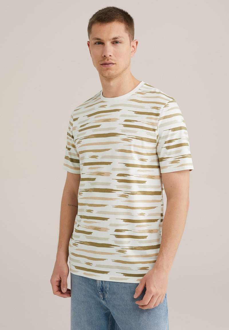 T-shirt cu mânecă scurtă, realizat dintr-un material moale, având o bază de culoare albastru deschis, cu dungi abstracte bej și măslin. Guler rotund, croială lejeră.
