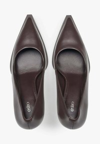 Brown leather high-heel shoes with a pointed toe and open sides. Smooth texture with a minimalistic design. Inscription reads "esito."