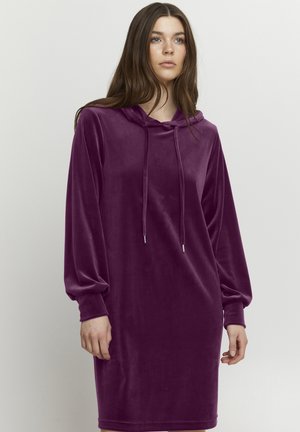 Mikina s kapucňou a dlhými rukávmi v hlbokej fialovej zamatovej farbe. Disponuje šnúrkami a sťahovacími manžetami, čo poskytuje uvoľnený strih a jemnú textúru.