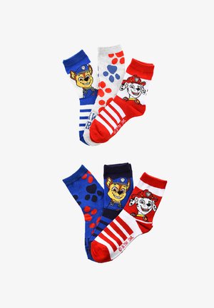 Three pairs of children’s socks with Paw Patrol characters Chase and Marshall, featuring paw prints and red, blue, white stripes.