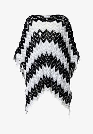 Zwart-wit zigzagpatroon poncho met een franjerand, gemaakt van een lichte brei-stof, met een oversized, ontspannen pasvorm.