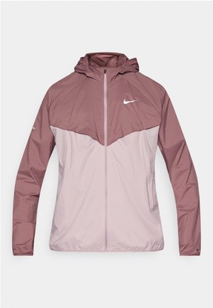 Jachetă windbreaker Nike cu design bicolor în nuanțe de mauve și roz pal, realizată din material ușor, cu glugă și fermoar frontal.