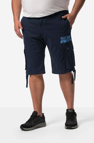 Navy cargo shorts with side pockets, featuring blue text that reads "FLIGHT LEVEL NO. 73-628." Adjustable tie hem detail. Worn with black sneakers.