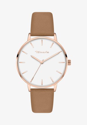 Montre en or rose avec un cadran blanc, marqueurs minimalistes et un bracelet en cuir brun clair. Design simple, finition lisse, forme ronde.