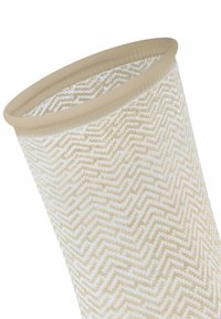 Beige Stoffkorb mit einem Zickzackmuster in Creme. Glatte Textur und eine runde, offene Oberseite mit einem festen, hellbraunen Rand.