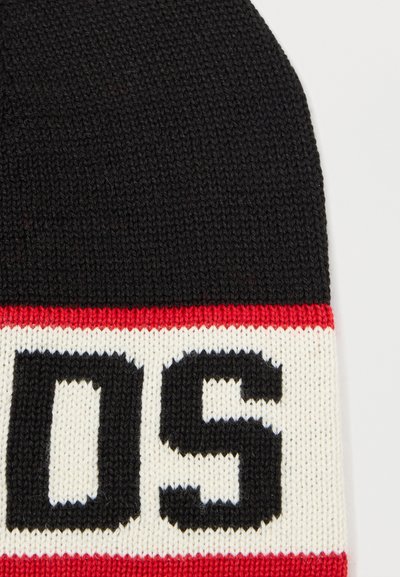 Gorro de malha preto com uma faixa vermelha e branca com letras pretas em negrito. Textura suave, forma arredondada, adequado para clima frio.