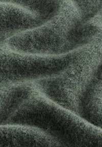 Textured green fabric with a soft, fuzzy surface, featuring a blend of dark and light green fibers, creating a subtle, natural appearance.