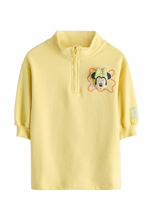 Yellow pullover with half-zip, soft fabric, with an embroidered Minnie Mouse design and a green accent label on the left sleeve.