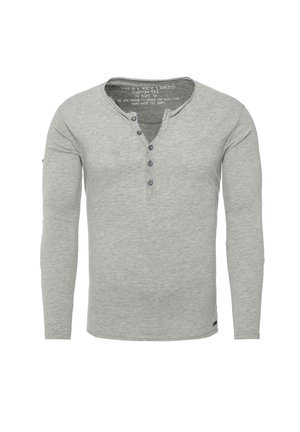 Grijze longsleeve henley shirt gemaakt van zachte stof, met een knoopsluiting en een subtiele textuur. Maat gemarkeerd als M.