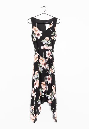 Robe noire sans manches avec imprimé floral rose et blanc, col en V, ourlet asymétrique, et ceinture attachée à la taille, suspendue à un cintre noir.