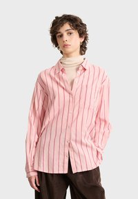 Pink striped button-up shirt with long sleeves, crafted from lightweight fabric. Features a chest pocket and a soft collar.