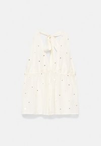 Top blanc sans manches avec lien halter au cou, dos en V, taille froncée et petites décorations en sequins argentés dispersées sur le tissu.