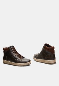 Brown leather high-top sneakers featuring a tan rubber sole, contrasting fabric collar, front laces, and a side zipper for easy wear.