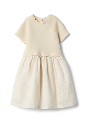 Vestito per bambino color crema con corpetto a maniche corte lavorato a maglia e gonna a motivo floreale in rilievo, con scollo smerlato.