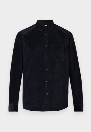 Mörkblå kordflöjls skjorta med långa ärmar, knappstängning fram, krage och bröstficka. Har texturerade ribbor och matchande knappar.