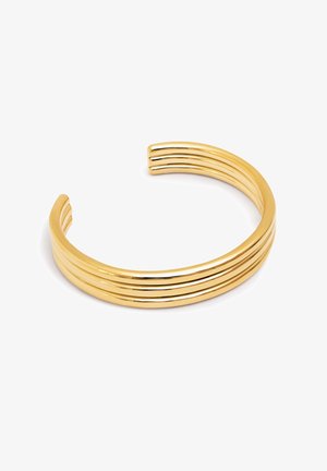 Zlatna manžetna narukvica s tri paralelne udubine, koja ima sjajnu, glatku površinu i otvorene krajeve za prilagodljivo nošenje.