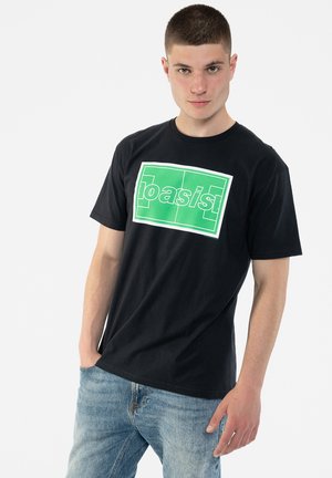 Black cotton t-shirt featuring a large green graphic that reads "basis" in bold white lettering, crew neck, and short sleeves.