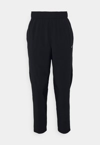 Sorte atletiske bukser med elastisk talje, tapered ben design, sidelommer og et lille logo på venstre forside.