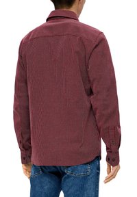 Czerwona i biała koszula w kratę z długim rękawem, z tylnym karczkiem, z guzikiem przy mankietach i prostym krojem. Tekstura materiału wydaje się gładka.