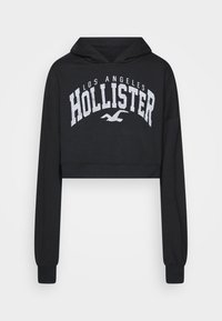 Felpa nera accorciata con cappuccio, stampa "LOS ANGELES HOLLISTER" in bianco, maniche lunghe, polsini a coste e tessuto morbido.
