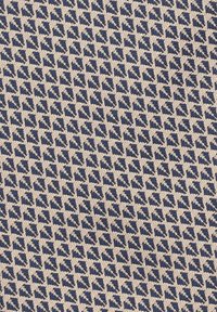 Tkanina w kolorze granatowym i beżowym, z geometrycznym wzorem małych trójkątów w naprzemiennie występujących kolorach, o teksturowanym, tkanym wyglądzie.