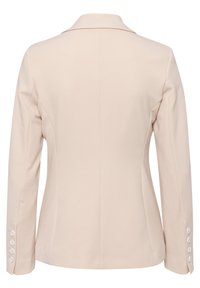 Blazer beige avec un col cranté, une coupe ajustée et des manches longues. Présente cinq accents de boutons sur chaque poignet et une texture de tissu lisse.