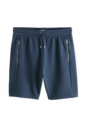 Marineblaue Freizeithose mit elastischem Bund, Kordelzug und vertikalen Reißverschlusstaschen auf beiden Seiten.