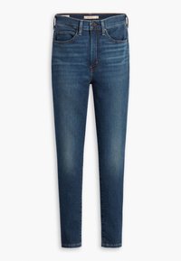 Vaqueros skinny azul oscuro con una textura suave, diseño de cinco bolsillos y trabillas. Desgaste ligero en las áreas del muslo y la rodilla. Cierre de botón clásico.