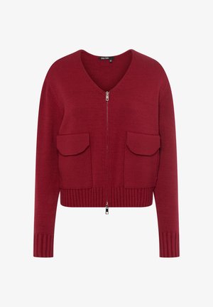 Red knitted cardigan with a v-neck, zip closure, and two front pockets. Ribbed hem and cuffs add texture and structure.