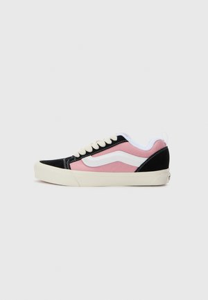 Sneakers featuring a black suede and pink canvas upper, white accents, a round toe, and cream rubber sole. Laces in a classic style.
