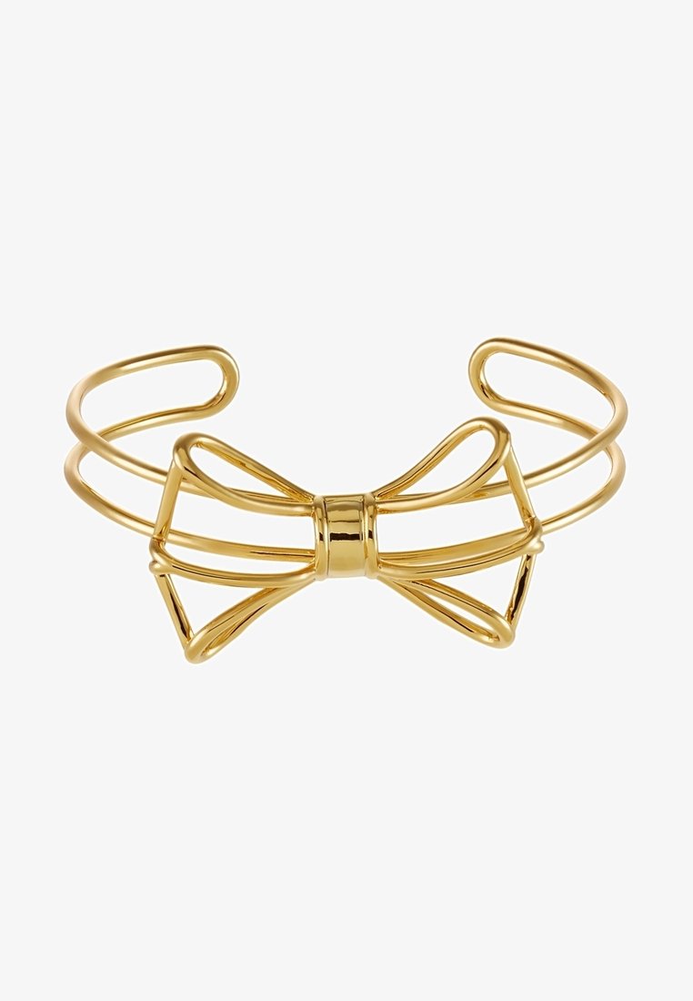Bracelet manchette ouvert ton or avec un design minimaliste de nœud en fil métallique au centre.