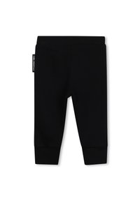 Zwarte katoenen leggings met een elastische tailleband en aangesloten boorden. Heeft een label aan de zijkant met witte tekst. Soepele textuur.