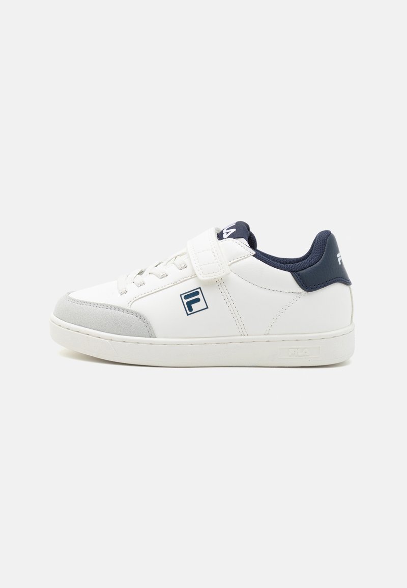 White sneaker with a leather upper, grey suede toe cap, navy accents, lace-up design, and a Velcro strap. Features a brand logo.