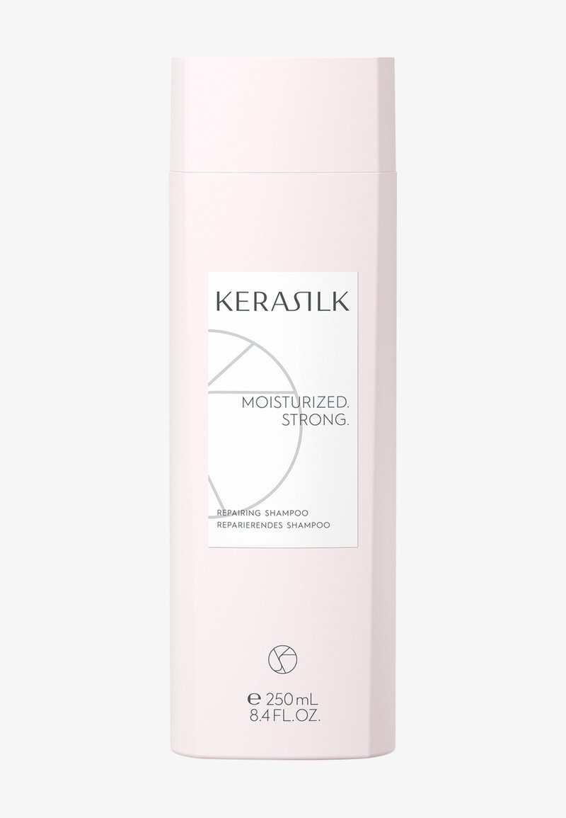 Flacon de shampooing réparateur Kerasilk, rose pâle, 250 ml, étiqueté « Hydraté. Fort. » avec un design circulaire minimaliste.